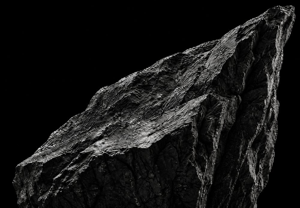 A dark rock face lit from one side.